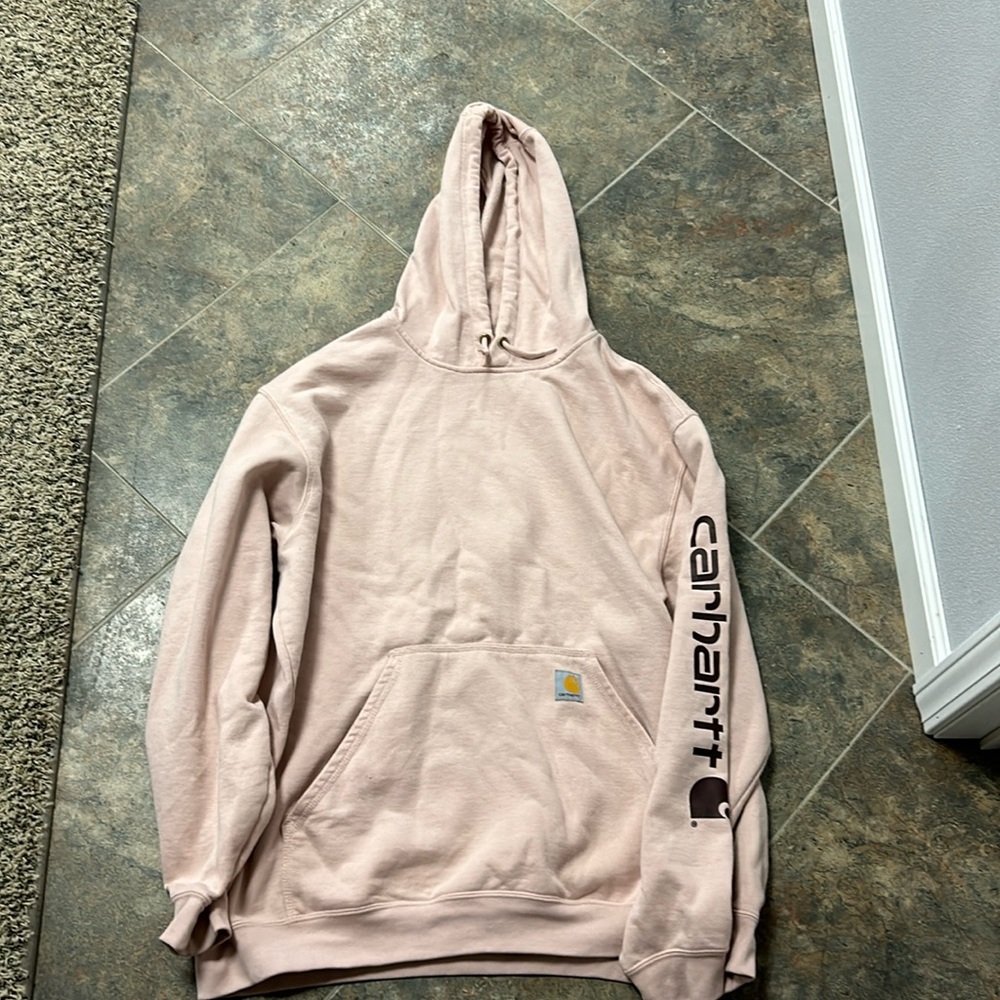 This is a Carrhartt sweatshirt, it’s an Xl, and it’s a light pink color.
